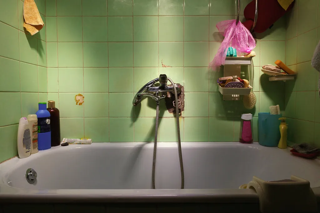 Original bathroom with dated green tile