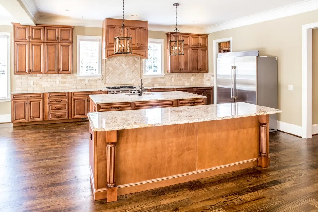 Completed kitchen with a large island and hardwood floors