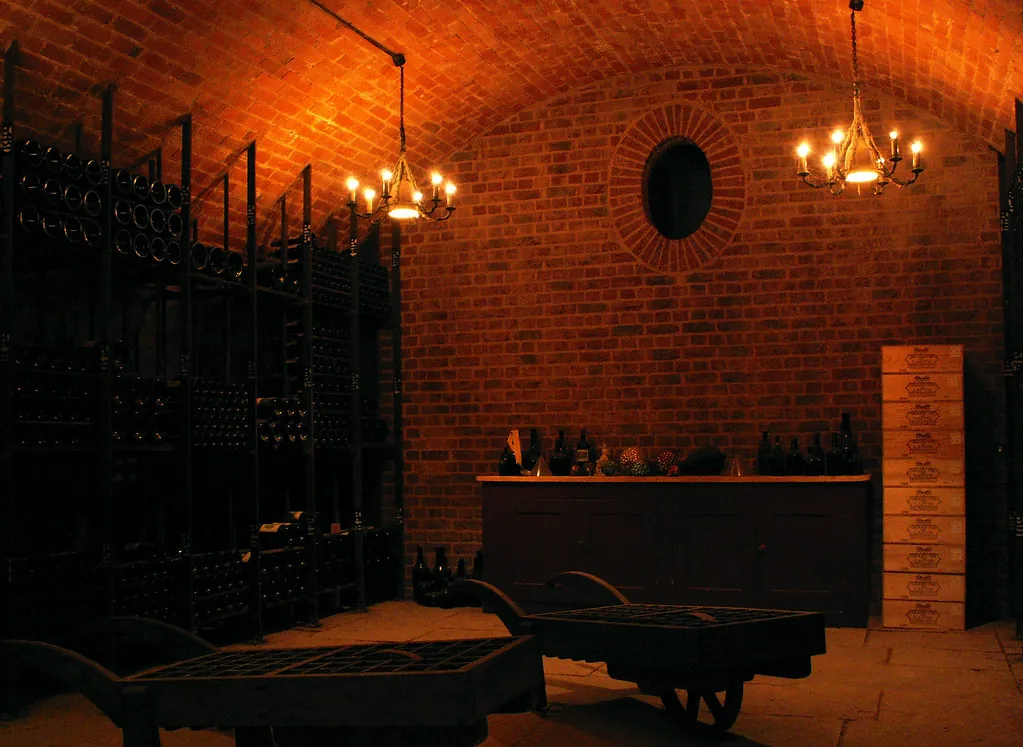 Brick-vaulted wine cellar lit by chandeliers