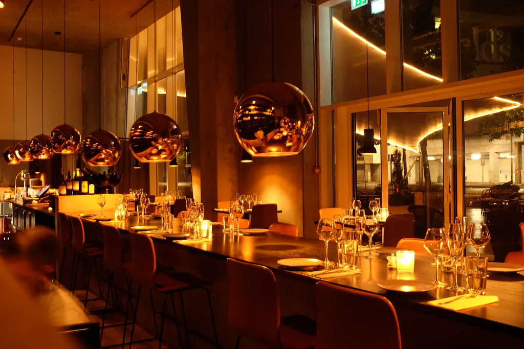 Warmly lit restaurant interior with copper pendant lamps